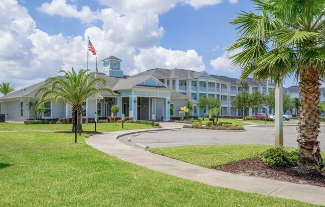 clubhouse with palm trees and a flag in front of it