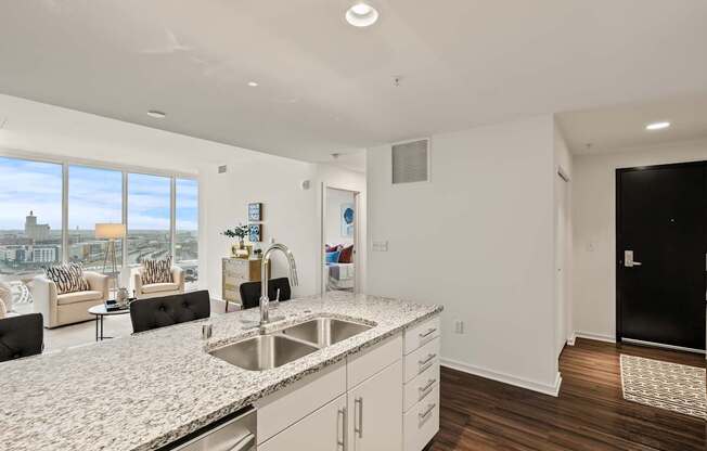 A modern kitchen with a large island and a view of the city.