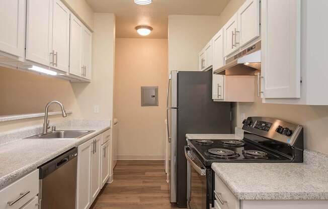 A kitchen with a black refrigerator and stove at Sunset Summit, Rocklin, CA, 95765