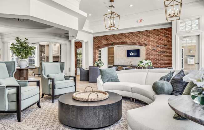 a living room filled with furniture and a brick wall