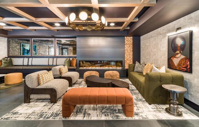 A moody hidden lounge with layered seating, game tables, and a fireplace that anchors the gathering space.