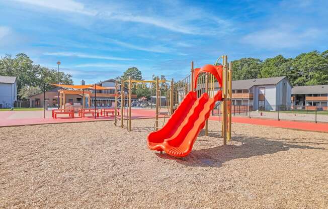 A playground with a red slide at The Marq apartments in Shreveport, LA