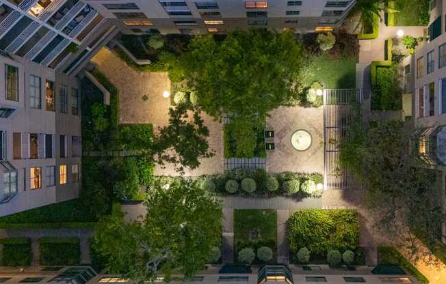 A courtyard surrounded by buildings with a clock on the wall.