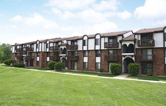 brick apartment building with a green lawn at Brookside Apartments in Springfield, MI