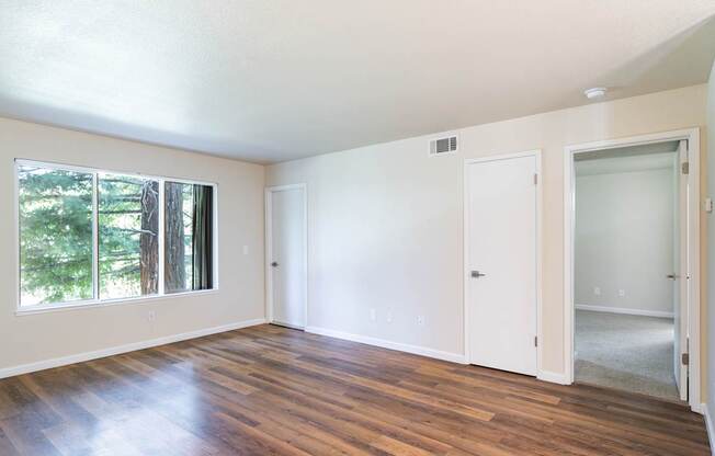 A room with wooden floors and white walls.