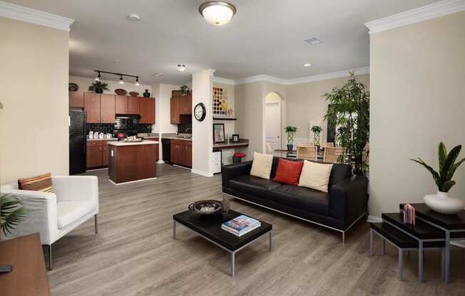 A living room with a black couch and a coffee table.