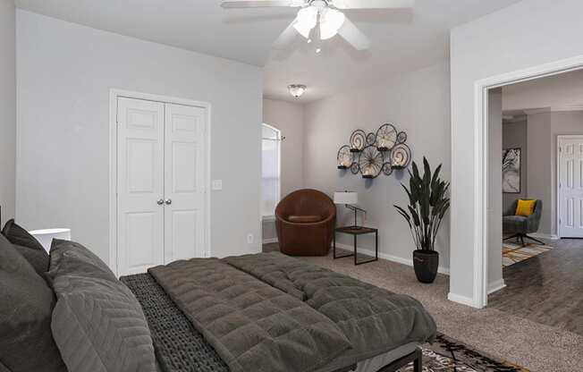 a bedroom with a bed and a ceiling fan