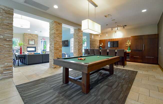 a pool table in the clubhouse at the preserve at great pond apartments in windsor
