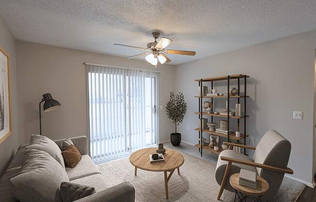 an open living room with a ceiling fan and a window