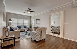 a living room with couches and chairs