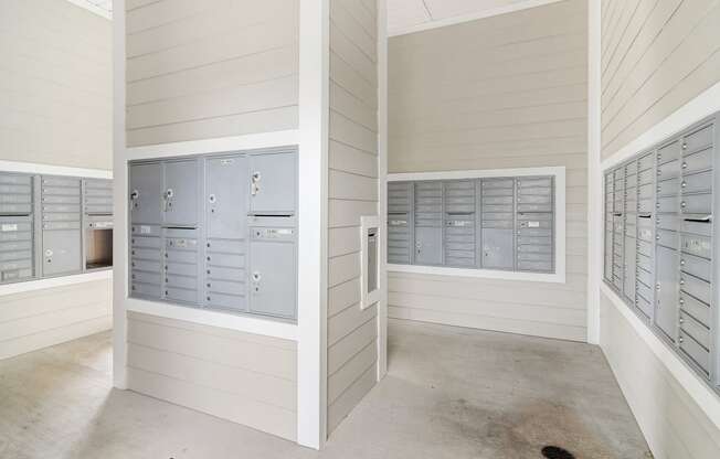 a row of lockers in a utility room with mailboxes