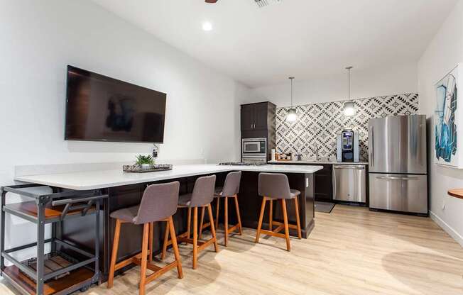 A kitchen with a white counter top and brown chairs.