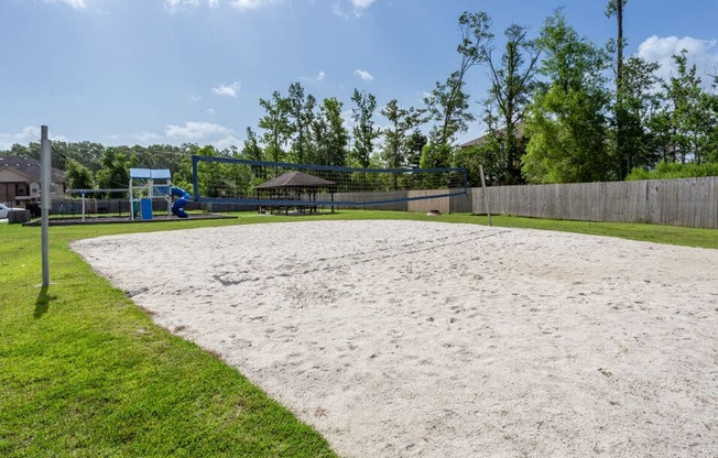 apartment complex with sand volleyball court