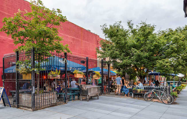 A red building with a tree in front of it.