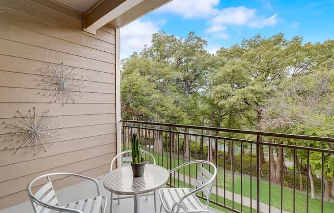 a patio with a table and chairs on a balcony