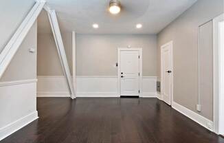A studio apartment in Pasadena with a white door and a closet at Brookmore Apartments..