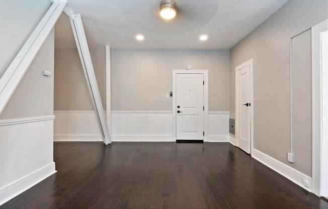 A studio apartment in Pasadena with a white door and a closet at Brookmore Apartments..