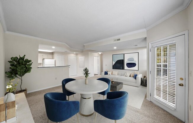 A white and blue living room with a round table and chairs.