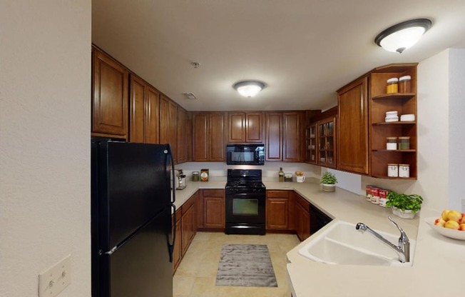 a kitchen with black appliances and wooden cabinets