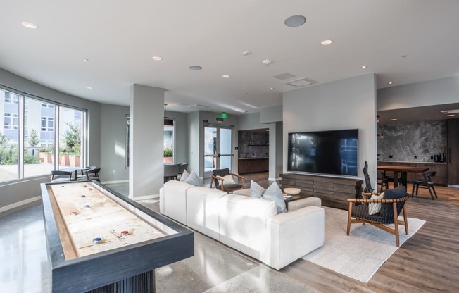 a large living room with a white couch and a pool table