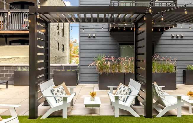 a group of white lounge chairs and tables on a patio