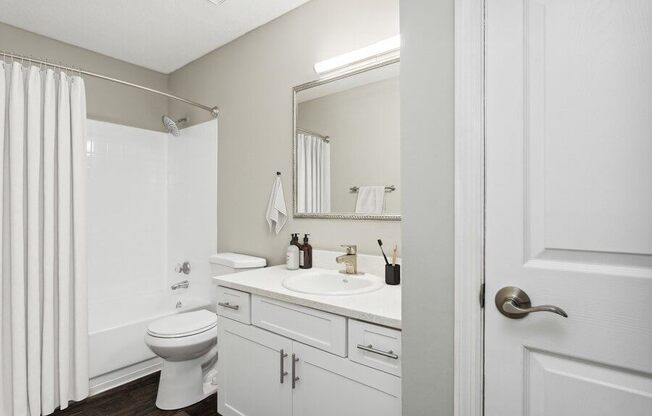 Model Bathroom Two with White Vanity at Caribbean Breeze Apartments in Tampa, FL.