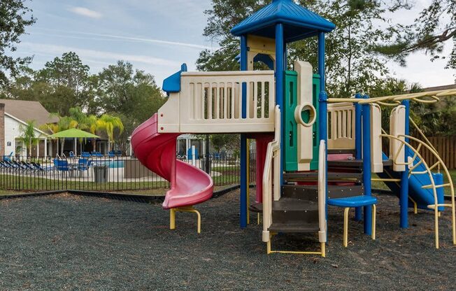 a colorful playground with a slide and other playground toys