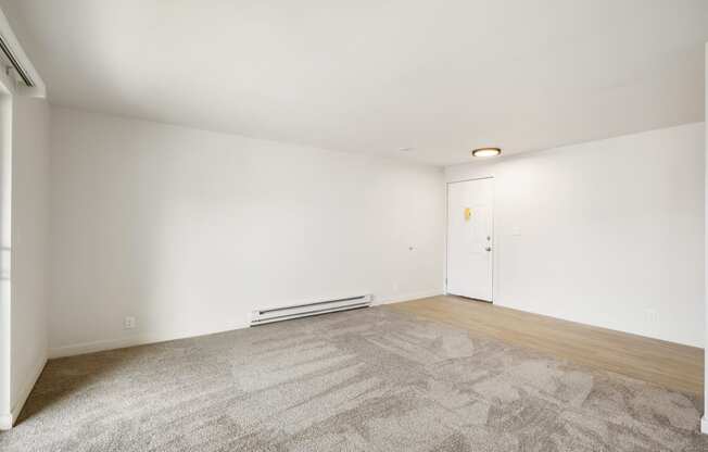 a living room with carpet, faux wood floors and white walls  at Brix, Washington