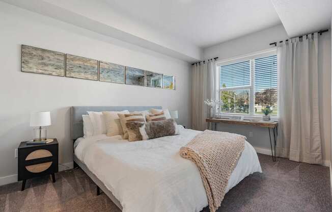 a bedroom with a large bed and a window