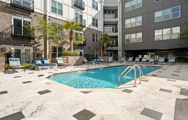 a swimming pool in front of an apartment building