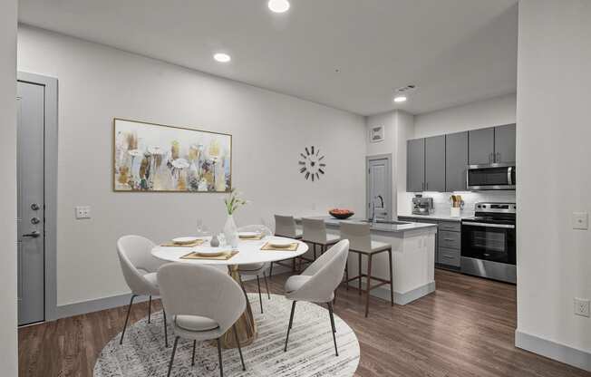 an open kitchen and dining room with a table and chairs