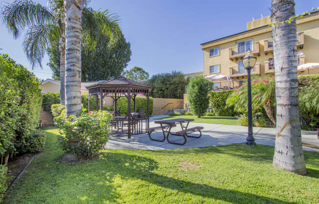 a backyard with a picnic table and a gazebo