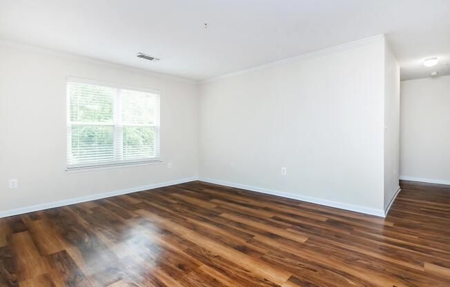 a close up of a hard wood floor next to a window
