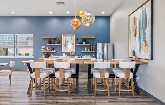 A dining room with a table set for six.