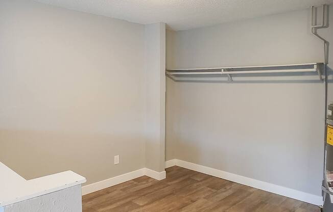 A room with a white ceiling and a wooden floor.