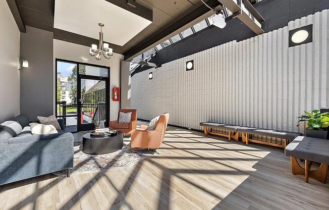 the lobby of a building with a couch and chairs at Troy Place Apartments - Troy, MI, Troy