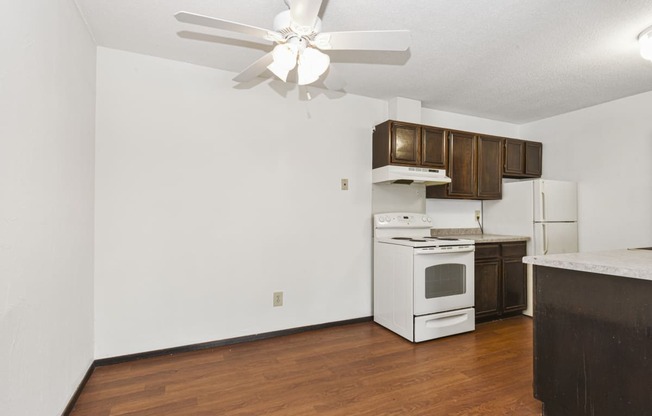 Fridley, MN Georgetown Apartments. A kitchen with white appliances and wooden cabinets