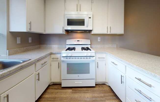 Apartments for Rent in Ontario CA  - Rancho Vista - Modern Kitchen With a Gas Stove, a Microwave, Sleek Counters, and Spacious Cabinets