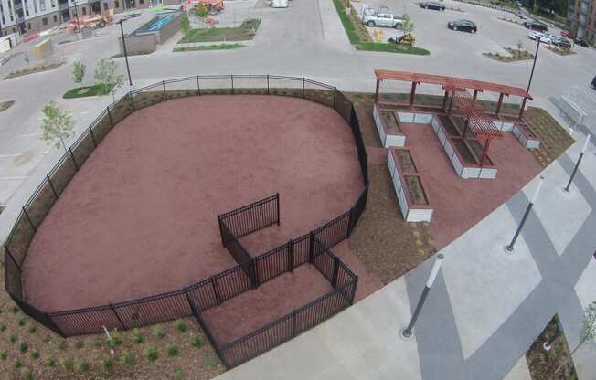 Fenced dog park with agility equipment.