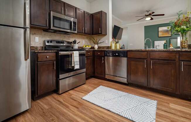 A kitchen with wooden cabinets and a refrigerator.