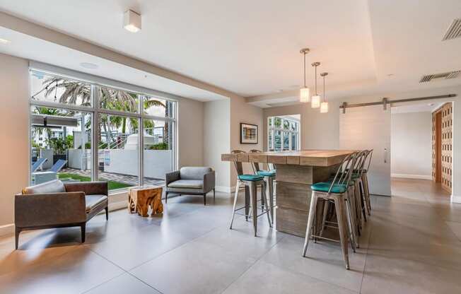 a kitchen and living room with a bar and a large window