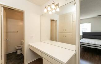 Bathroom with White Cabinets and Hardwood Floors