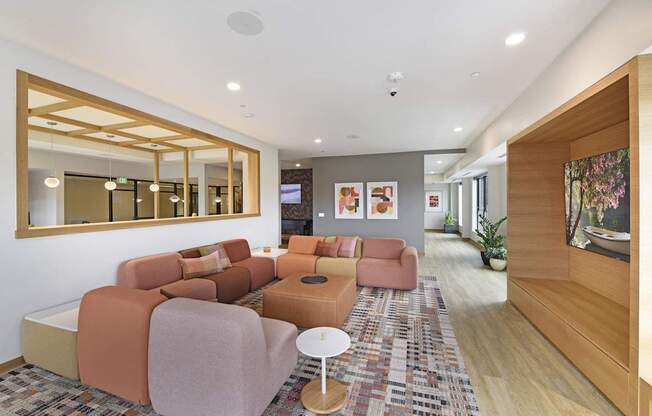 A living room with a large mirror and a rug.
