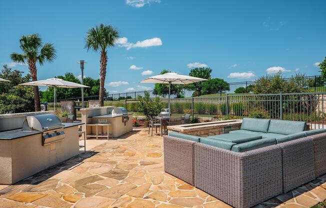 outdoor grilling area at the green at plum creek apartments