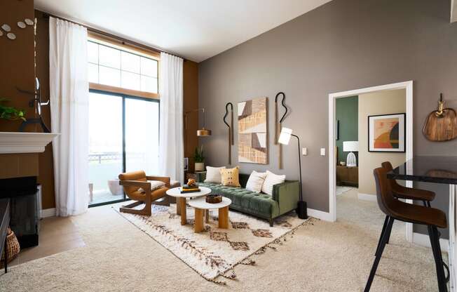 a living room with a green couch and two tables