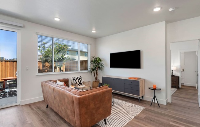 an open living room with a couch and a tv