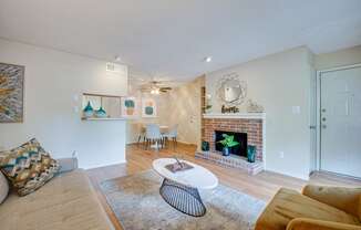 a living room with a fireplace and a couch and a table