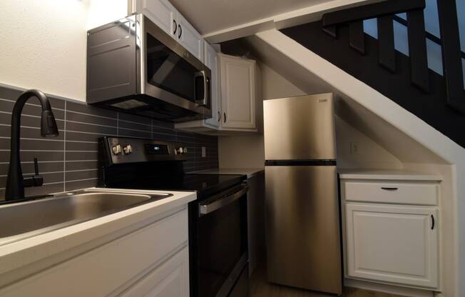 a kitchen with a sink and a refrigerator