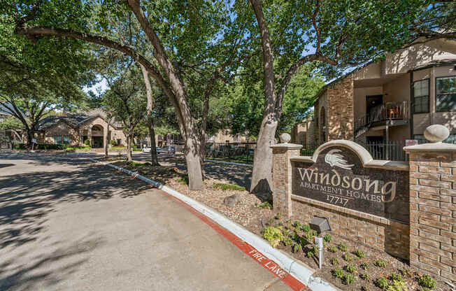A sign for Windson Homes stands in front of a building.