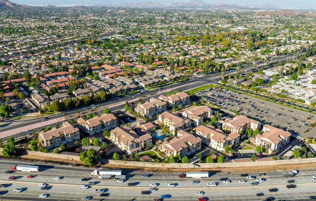 an aerial view of an intersection with cars and houses